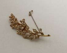 A large Victorian pearl brooch in the form of a fl