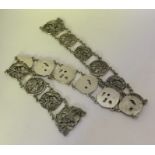 A heavy Chinese silver panelled belt decorated wit