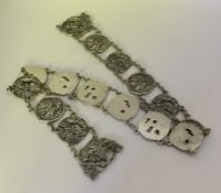 A heavy Chinese silver panelled belt decorated wit