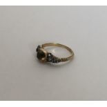 A Georgian five stone ring with rubover mount and