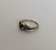 A Georgian five stone ring with rubover mount and