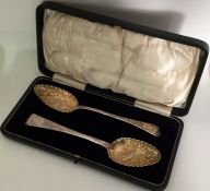 A good pair of Georgian silver berry spoons with g