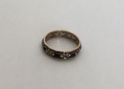 A sapphire mounted and 9 carat eternity ring. Appr