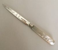 A stylish silver and MOP butter knife decorated wi