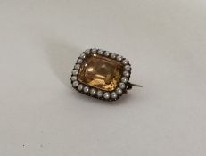 A Victorian gold, pearl and yellow stone brooch. A