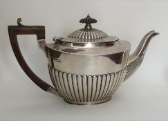 A heavy silver half fluted teapot. London. Approx.