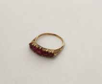 An 18 carat ruby five stone tapering ring in claw
