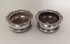 A pair of silver plated bottle coasters. Est. £10