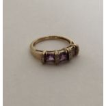 An amethyst and diamond Art Deco style ring in cla