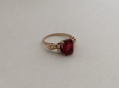 A red stone ring in 9 carat claw mount. Approx. 3.