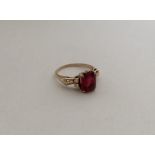 A red stone ring in 9 carat claw mount. Approx. 3.