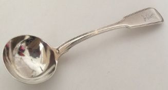 A fiddle and thread pattern silver sauce ladle wit