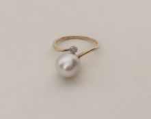 A pearl and diamond cluster ring in 9 carat mount.