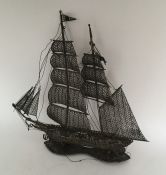 A large silver filigree model of a sailing boat. A