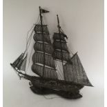 A large silver filigree model of a sailing boat. A