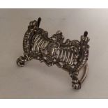 An Edwardian silver menu holder attractively decor