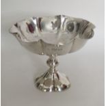 A heavy silver sweet dish with crimped rim to shap