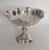 A heavy silver sweet dish with crimped rim to shap