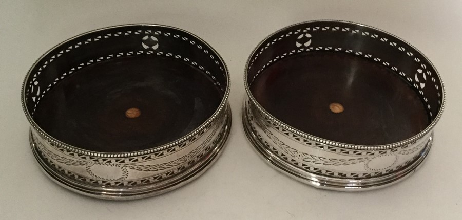 A pair of Continental silver wine coasters with sw - Image 2 of 2