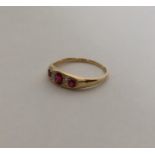 A ruby and diamond seven stone ring in 18 carat mo