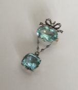 A massive Victorian aquamarine and diamond bow brooch with m