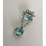 A massive Victorian aquamarine and diamond bow brooch with m