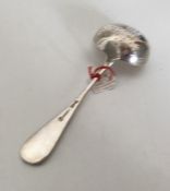 A Russian silver and silver gilt sifter spoon with