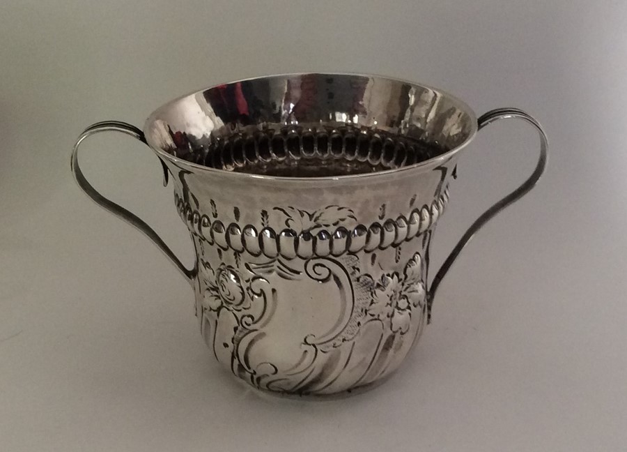 A good Georgian silver porringer of half fluted de