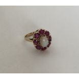 A large opal and ruby cluster ring set in 9 carat