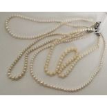 A double string of pearl beads together with two o