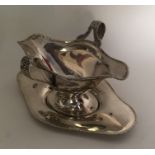 A good quality double lipped silver sauce boat on