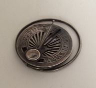 An unusual silver travelling compass / sun dial. A