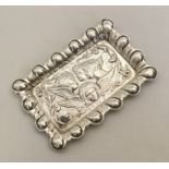 A rectangular silver pin tray mounted with cherubs