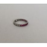 An attractive diamond and ruby eternity ring engra