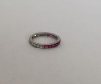 An attractive diamond and ruby eternity ring engra