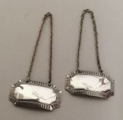 A pair of silver wine labels with cut corners. Bir