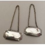 A pair of silver wine labels with cut corners. Bir