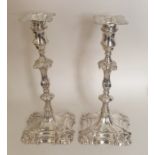 A good pair of George II cast silver candlesticks