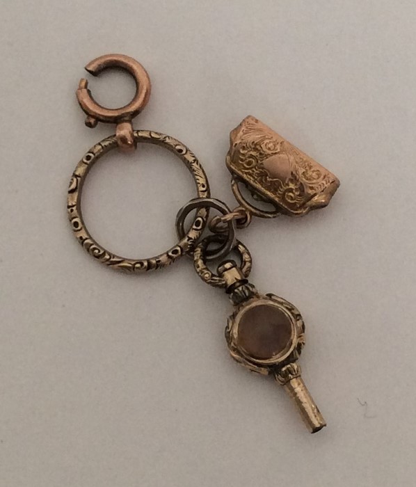 An Antique gold watch key together with a purse et