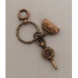 An Antique gold watch key together with a purse et