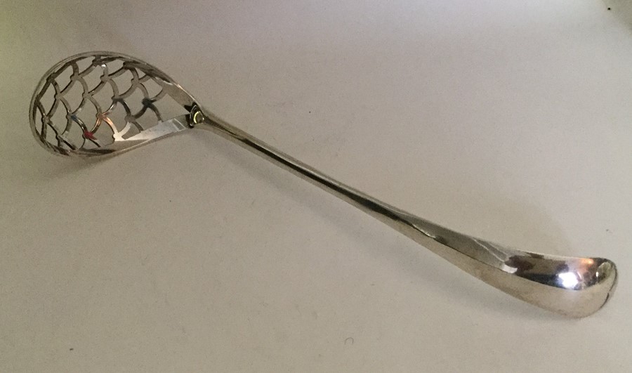 A large Dutch silver sifter spoon with pierced bow