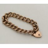 A good quality 9 carat curb link bracelet with cha