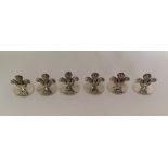 A good set of six silver menu holders in the form