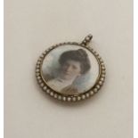 A Victorian gold and pearl circular locket with lo