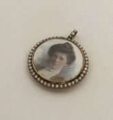 A Victorian gold and pearl circular locket with lo