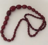 A good string of red amber beads. Approx. 103 grams. Est. £250 - £350.