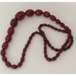 A good string of red amber beads. Approx. 103 grams. Est. £250 - £350.