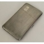 An engine turned silver hinged top cigarette case.
