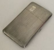 An engine turned silver hinged top cigarette case.