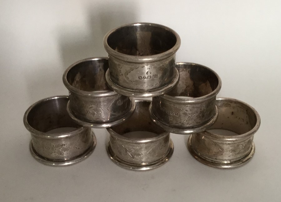 A set of six silver napkin rings with engraved dec